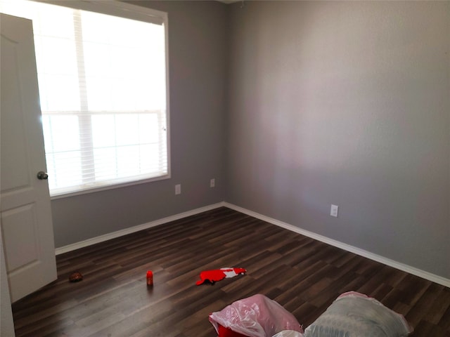 unfurnished room with dark hardwood / wood-style floors