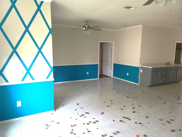 unfurnished room with ornamental molding, ceiling fan, and light tile floors