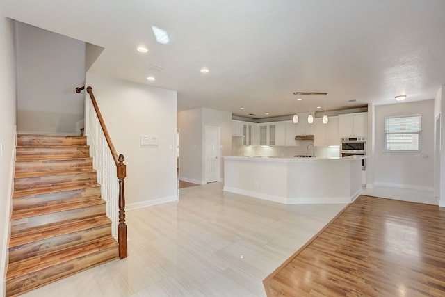 interior space with light hardwood / wood-style floors and sink