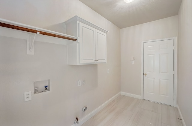 washroom with cabinets, hookup for a washing machine, hookup for an electric dryer, and hookup for a gas dryer