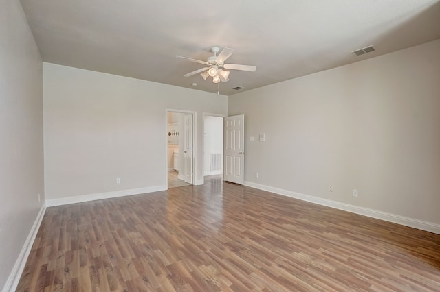 empty room featuring hardwood / wood-style floors and ceiling fan