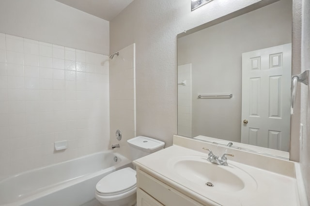 full bathroom with tiled shower / bath combo, vanity, and toilet