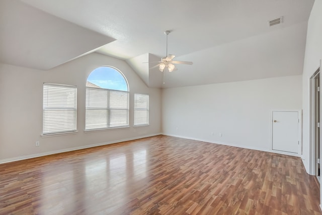 empty room featuring hardwood / wood-style floors, vaulted ceiling, and ceiling fan