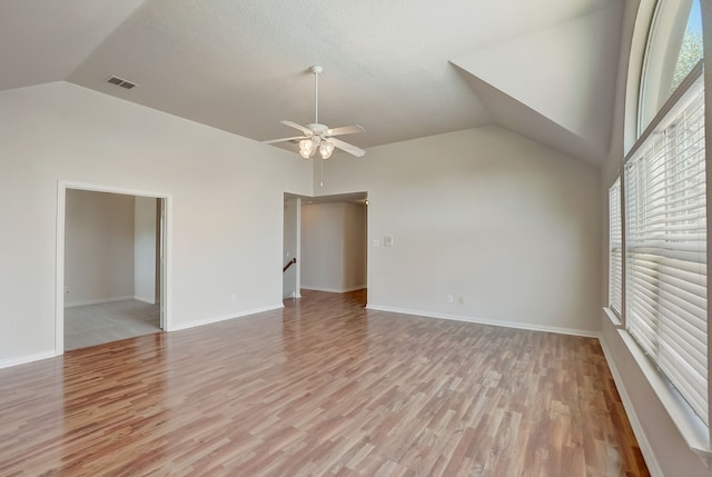 unfurnished room featuring light hardwood / wood-style flooring, ceiling fan, and vaulted ceiling