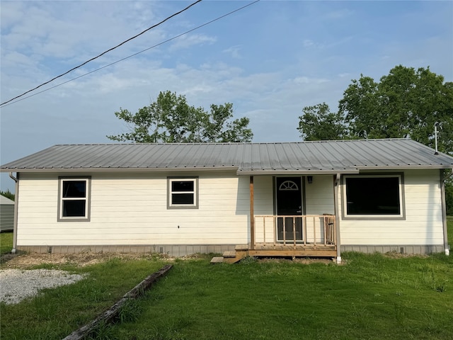 ranch-style house with a front yard and covered porch