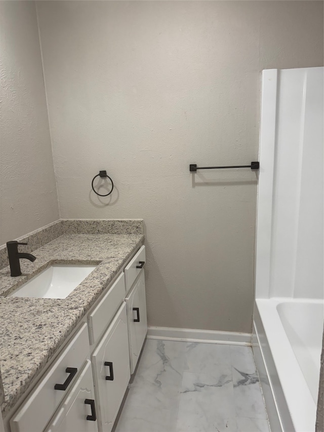 bathroom with tile flooring and vanity