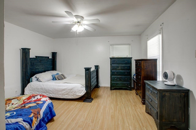 bedroom with light hardwood / wood-style floors and ceiling fan