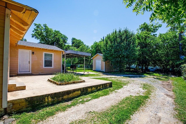 view of yard with a patio and an outdoor structure