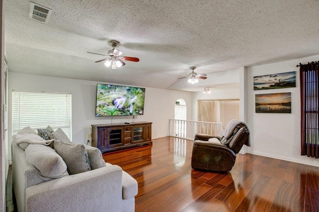 living room featuring a healthy amount of sunlight, a textured ceiling, ceiling fan, and hardwood / wood-style floors