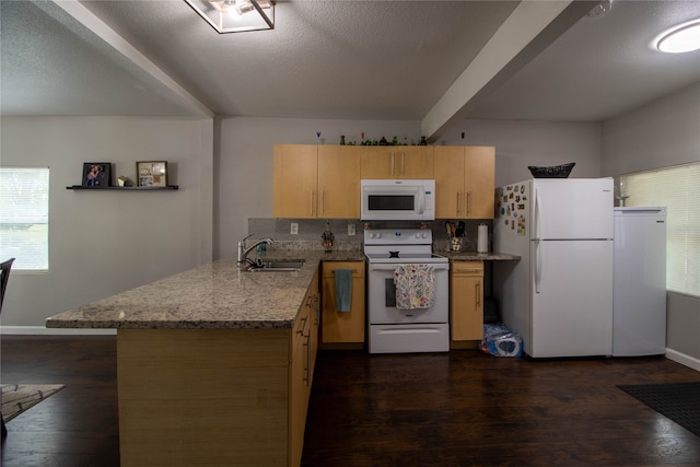 kitchen with kitchen peninsula, dark hardwood / wood-style flooring, white appliances, and sink