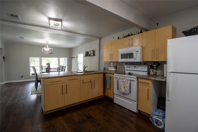 kitchen with white appliances, dark wood-type flooring, kitchen peninsula, tasteful backsplash, and a textured ceiling