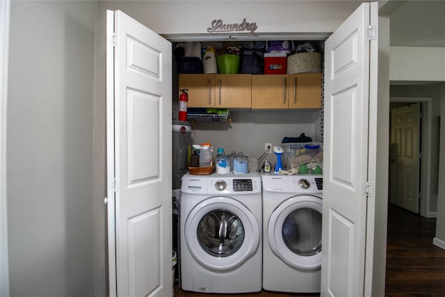 laundry area with washer and clothes dryer and dark wood-type flooring