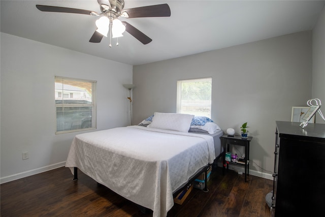 bedroom with dark hardwood / wood-style floors and ceiling fan