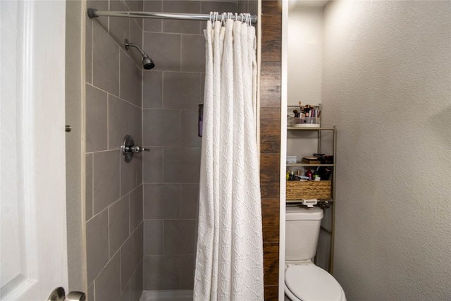 bathroom featuring walk in shower and toilet