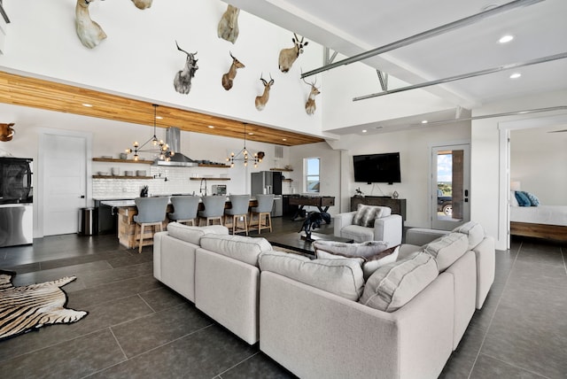 tiled living room with an inviting chandelier