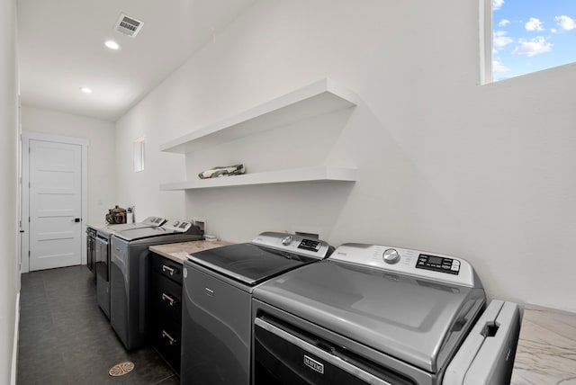 clothes washing area featuring independent washer and dryer