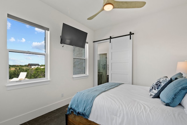 bedroom with a barn door and ceiling fan