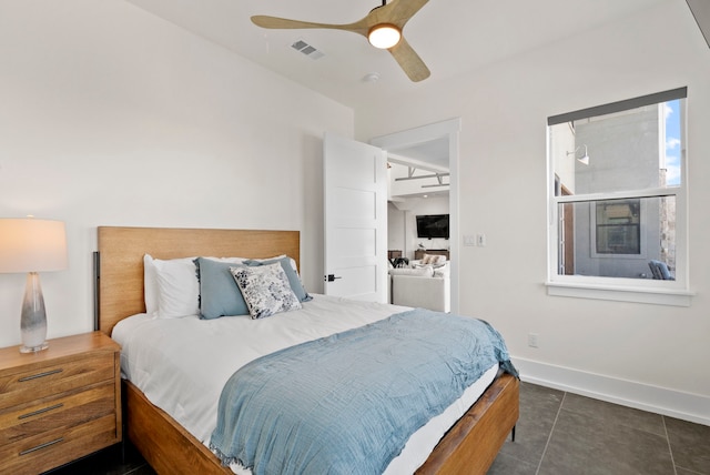 bedroom featuring dark tile patterned flooring and ceiling fan