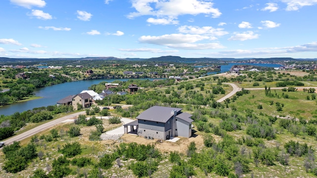 drone / aerial view featuring a water and mountain view