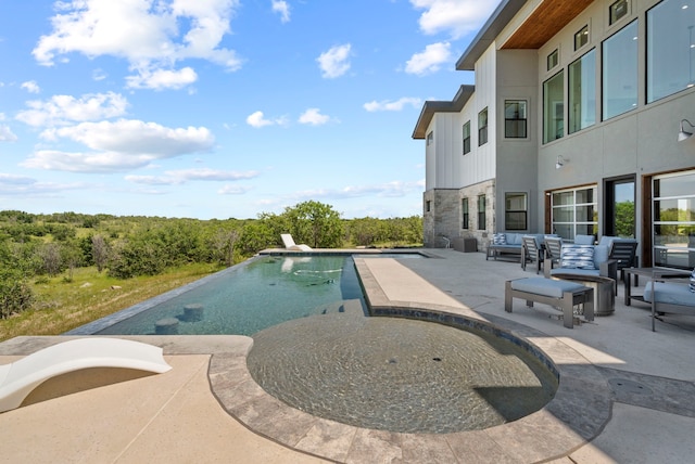 view of pool with outdoor lounge area and a patio area