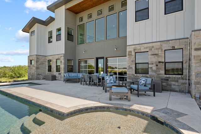 rear view of house with a patio and an outdoor hangout area