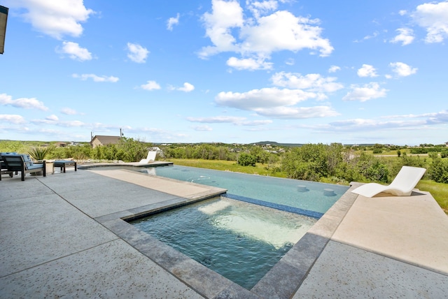 view of pool with a patio and an in ground hot tub