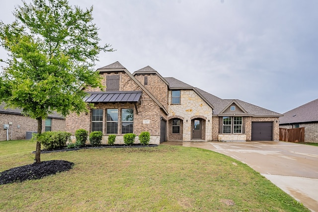 view of front of property with a front lawn and a garage