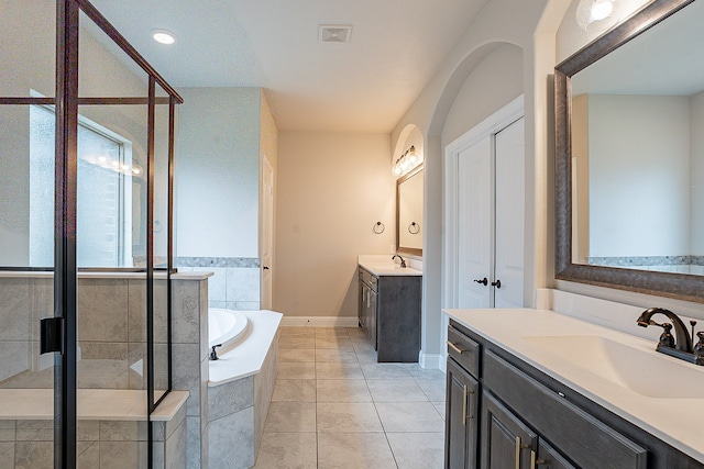 bathroom with plus walk in shower, vanity, and tile flooring