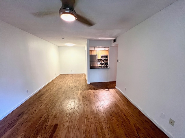 interior space featuring hardwood / wood-style floors and ceiling fan