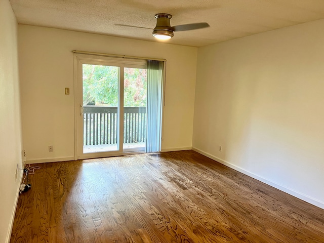 unfurnished room with ceiling fan, hardwood / wood-style flooring, and a textured ceiling