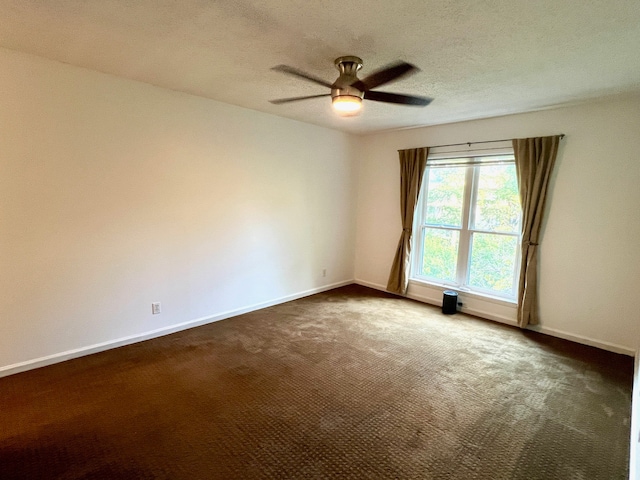 carpeted spare room featuring a textured ceiling and ceiling fan