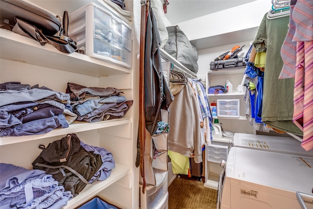 spacious closet with carpet and washing machine and clothes dryer