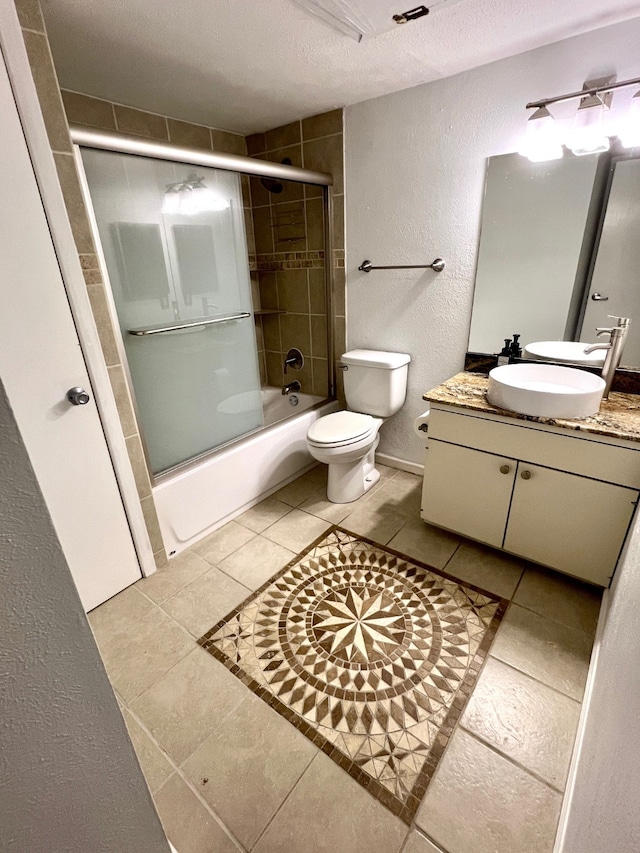 full bathroom featuring tile patterned floors, toilet, vanity, enclosed tub / shower combo, and a textured ceiling