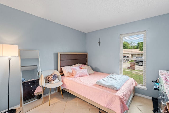 tiled bedroom featuring multiple windows