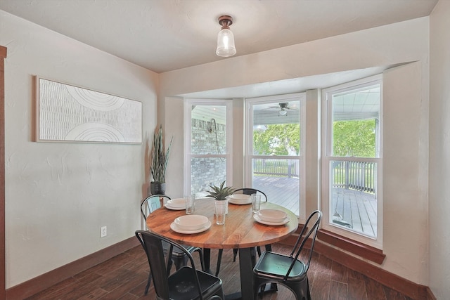 dining space with dark wood-type flooring