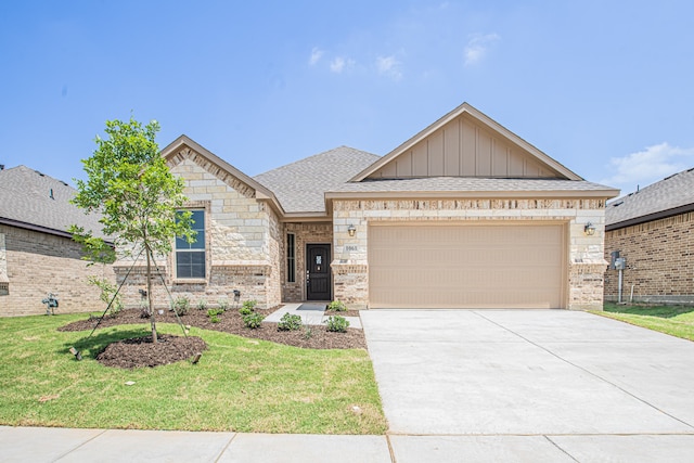 view of front of property with a garage and a front lawn