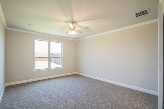 empty room with ceiling fan, carpet floors, and crown molding