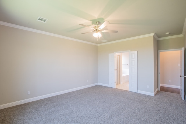 unfurnished bedroom featuring ceiling fan, crown molding, carpet flooring, and ensuite bathroom