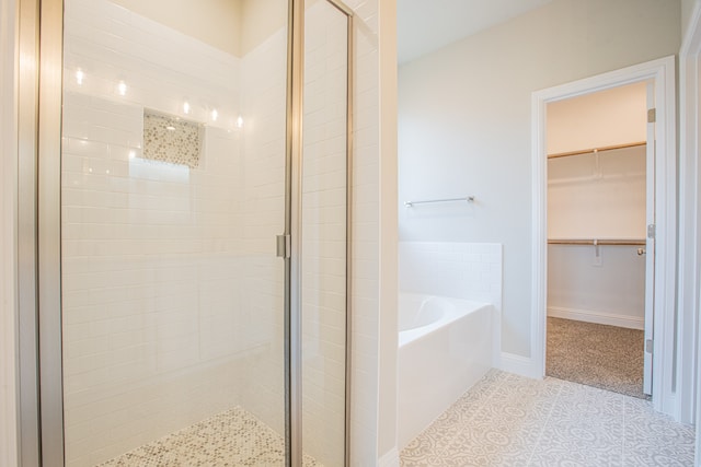 bathroom with tile floors and independent shower and bath