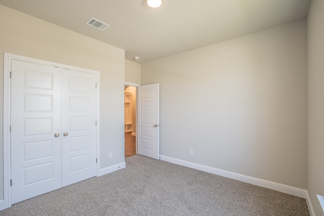 unfurnished bedroom with carpet and a closet