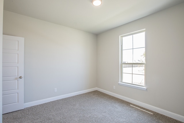 carpeted empty room featuring plenty of natural light