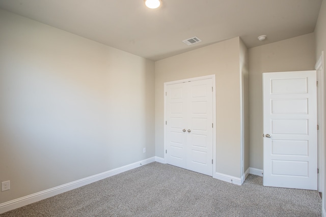 unfurnished bedroom featuring a closet and carpet