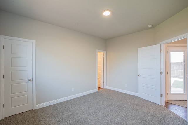 empty room with a healthy amount of sunlight and carpet