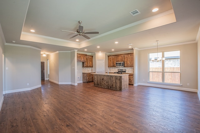 unfurnished living room with crown molding, dark wood-type flooring, and a raised ceiling