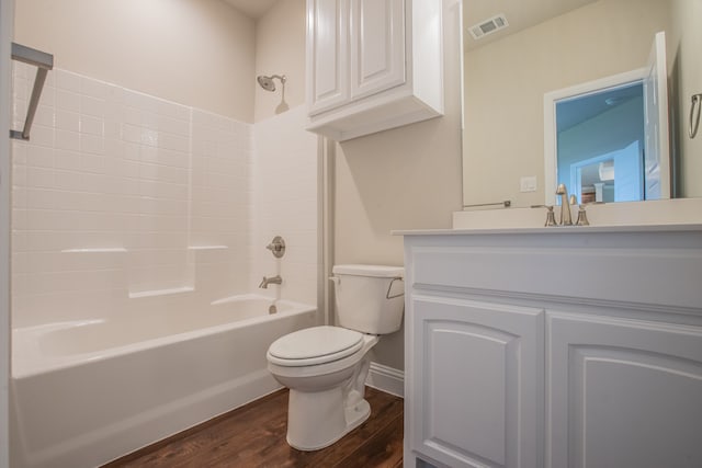 full bathroom featuring toilet, hardwood / wood-style flooring,  shower combination, and large vanity