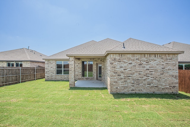 back of property with a patio and a yard