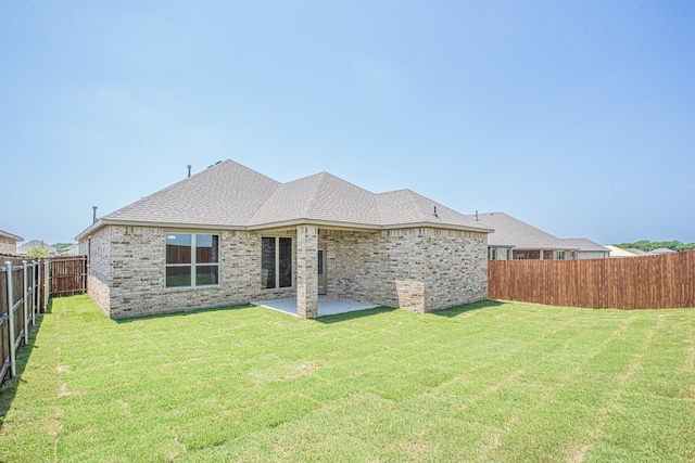 rear view of house with a patio area and a yard