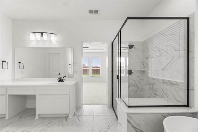 bathroom with an enclosed shower, vanity, and tile flooring