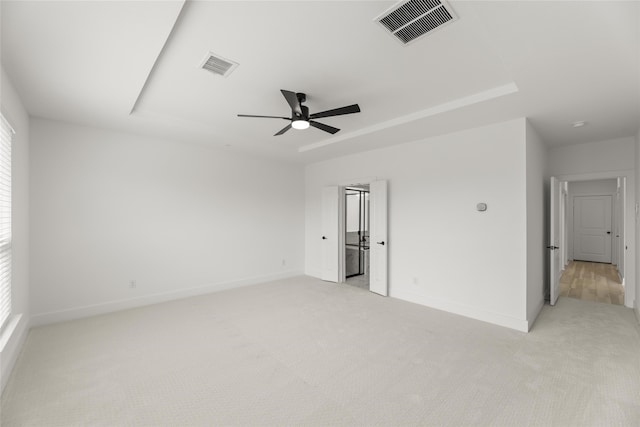 empty room with light colored carpet and ceiling fan