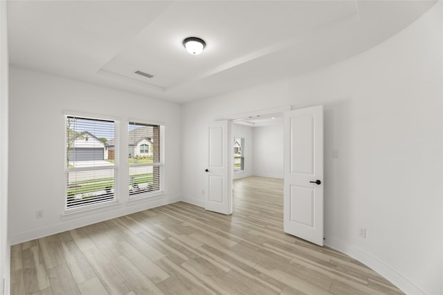 empty room with light hardwood / wood-style flooring